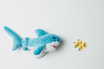 Toy shark swimming after scattered pills