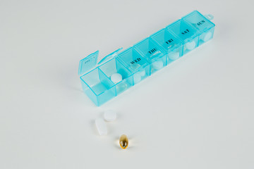 Pill organizer and pills scattered out of it