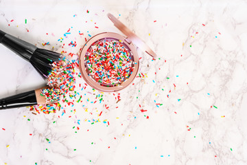 Multi colored blush or highlighter  like sweet sugar decoration in pastel pink color box with paint...