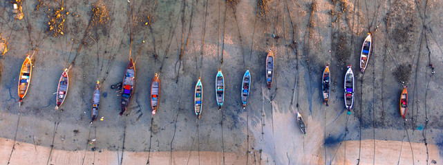 Aerial view of fishing boats at low tide