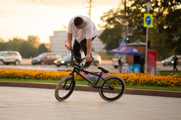 The guy performs a BMX trick in a jump.