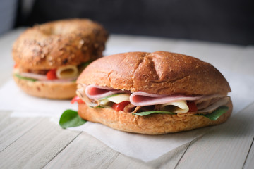 Delicious classic blt sandwiches with ham, cheese, bacon, tomatoes. Breakfast and fast food meal. on isolated black background wooden and text copy space.