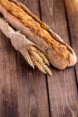 Assortment of baked bread on wooden table background