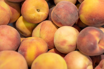 Fresh peaches in a supermarket, background texture.