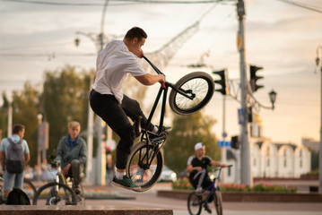 The guy on the BMX jumps up on the parapet.