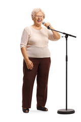 Cheerful grandmorther standing in front of a microphone