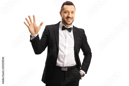 Young man in a suit showing five fingers on hand