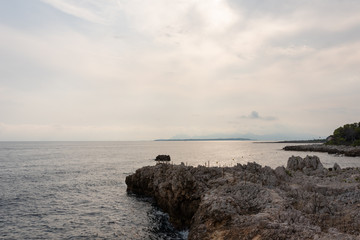 Stone sea shore during sunset. Cap d'Antibes trail, cote d'azur, France. 