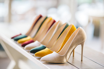 Women's shoes on the chair. Women's shoes with heels in various colors