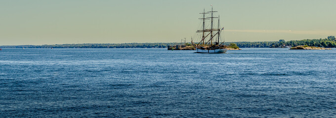 Panorama of a Tall Ship next to islands in the St.Lawrence River.