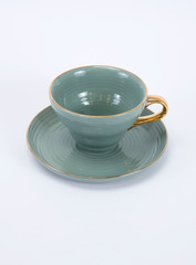 Obraz na płótnie Canvas Empty green ceramic coffee or tea cup and saucer with golden handle isolated on white background_2
