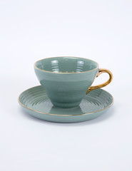 Empty green ceramic coffee or tea cup and saucer with golden handle isolated on white background_3