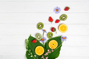 Summer subject photography. Fruits and flowers on a white board