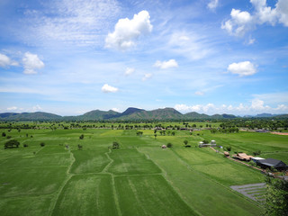 At Kanchanaburi Thailand back area Suea cave temple have large Vast green fields, mountain and beautiful sky.
