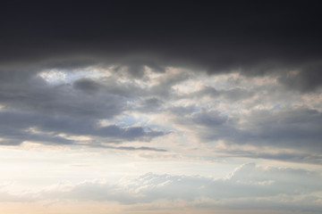 Obraz premium Dark thunder clouds on the blue sky. Abstract background with clouds on blue sky.