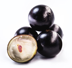 The jabuticaba or jabuticaba is a purplish black-white fruit, typical fruit of Brazil, on isolated white background. Rare organic and healthy fruits in South America, also known as Brazilian grapes.