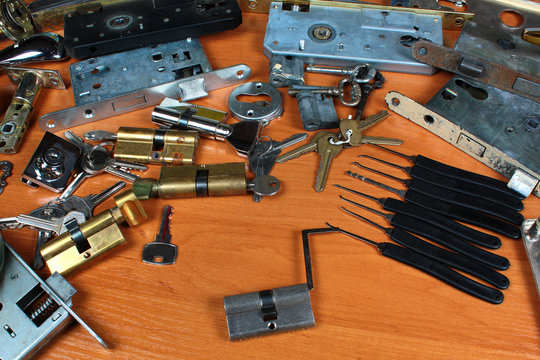 Locksmith workshop. Keys, locks and picklocks on table