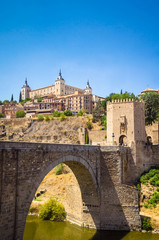 Fototapeta na wymiar Panoramic view of Alcazar and Alcantara Bridge in the city Toledo, Spain.