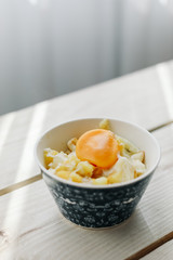 cheese and potato eggs in a bowl.  fried potatoes with fried eggs, rustic breakfast