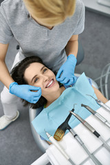 Pretty woman's teeth cleaning in dental clinic