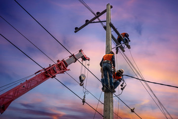 Electrician lineman with cranes and hoists repairman worker at climbing work on electric post power pole - obrazy, fototapety, plakaty