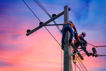 Electrician lineman repairman worker at climbing work on electric post power pole - Powered by Adobe