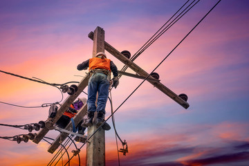 Electrician lineman repairman worker at climbing work on electric post power pole - obrazy, fototapety, plakaty