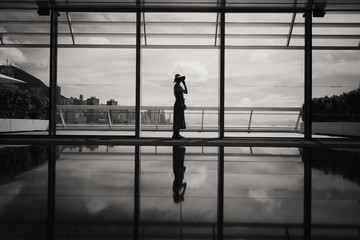 Fototapeta na wymiar Woman stand in front of windows