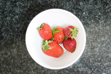 Above view of some strawberry on a white dish
