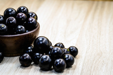 Fruit called Jaboticaba or jabuticaba in a basket on a white background, preserves organic and healthy fruits.