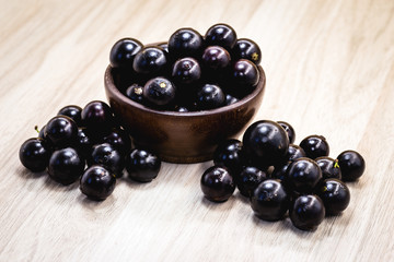 Fruit called Jaboticaba or jabuticaba in a basket on a white background, preserves organic and healthy fruits.