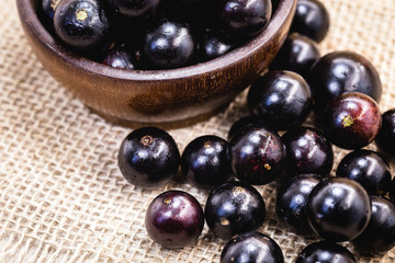 Fruit called Jaboticaba or jabuticaba in a basket on a white background, preserves organic and healthy fruits.