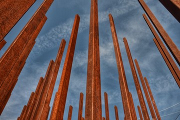 Rusty metal sticks and a cloudy blue sky 