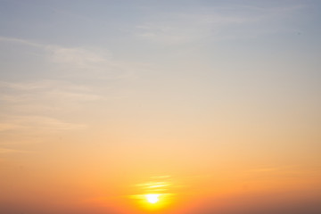 Dramadic Sunset Sky blue and orange light of the sun through the clouds in the sky