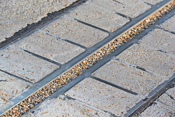 abstract metal line barrier on stone surface closeup, technology diversity