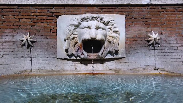 Ancient Roman fountain decorated with bas relief sculture of lion head in Parco Adriano near Castel Sant'Angelo in Rome city, Italy. Royalty free UHD 4K stock footage for Italian and European cilture.