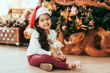 Happy little smiling girl with christmas gift