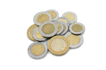 A close up macro image of a pile of Mexican peso coins cut out on a white background