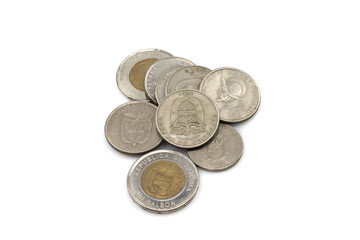 An assortment of silver and bimettalic coins, close up in macro from Panama on a white, clean background