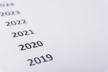 List of recent years on white paper. Focus on 2020. Copy Space