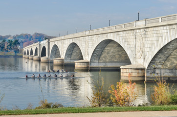 Fototapeta na wymiar Memorial Bridge in autumn foliage and kayak riders n Potomac River - Washington D.C. United States of America
