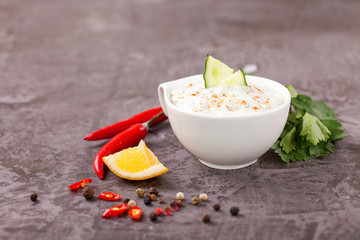 Tzatziki sauce in a  sauce-boat. Ingredients for a dzadziki. Turkish dish cacik. Selective focus. Copy space