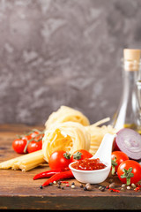 Tomato sauce and paste on a wooden background. Selective focus. Copy space