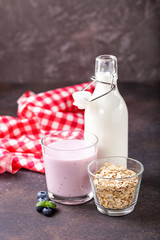 Milk, yogurt and oatmeal against a dark background. Selective focus. Copy space