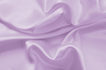 Delicate satin draped fabric of lilac color texture for festive backgrounds