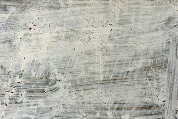 Fototapeta premium Texture of a concrete wall with cracks and scratches which can be used as a background