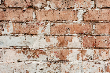 Naklejka premium Texture of a brick wall with cracks and scratches which can be used as a background