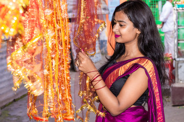 Beautiful Indian woman shopping decorative products for Diwali and festive season 