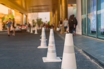 The white traffic cones are set up as a pedestrian safety zone in front of the mall.