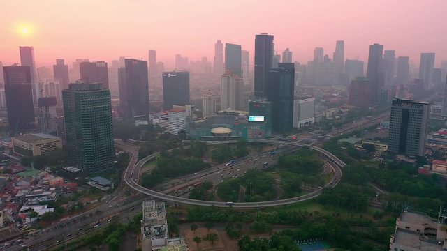reveal view of semanggi bridge interchange Jakarta from a drone with dolly motion, during extreme air pollution. dolly motion